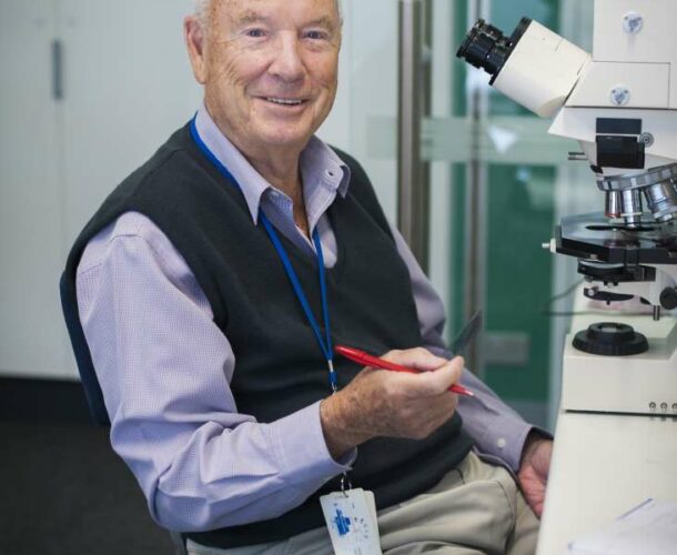 Professor Don Metcalf at the microscope on his 85th birthday.