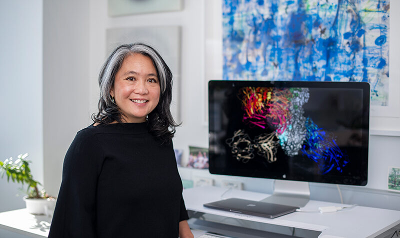 Wai-Hong Tham sitting at a desk with a computer in the background