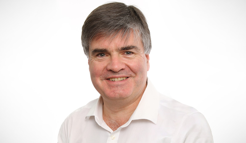 Head-and-shoulders photo of Professor Ken Smith smiling at the camera